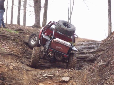 1978 Ford Bronco - Off-road vehicle navigates a challenging, steep, rocky terrain.