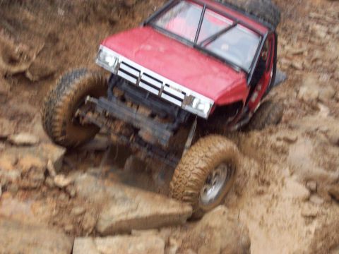 1978 Ford Bronco - Off-road vehicle tackling challenging rocky and muddy terrain.