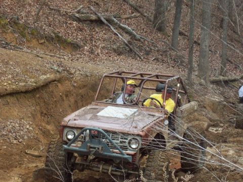 1978 Ford Bronco - A 1978 Ford Bronco navigates a challenging off-road course with two occupants.