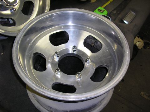 1987 Ford Bronco - A close-up view of an aluminum wheel, showing the lug nut pattern and rim detail.