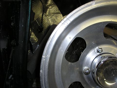 1987 Ford Bronco - Detail shot of a vehicle's wheel and inner fender area.