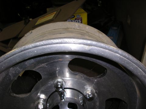 1987 Ford Bronco - Close-up view of an aluminum wheel, showing the lug nut pattern and rim detail.