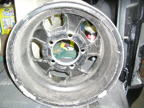 1987 Ford Bronco - A dusty black alloy wheel is shown, with a US patent number visible on its surface.