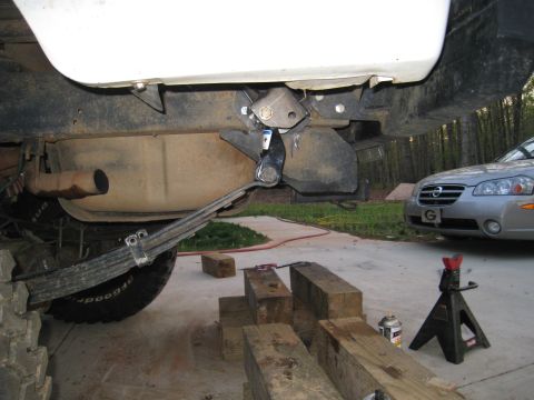 1996 Ford Bronco - Truck rear suspension components and a nearby sedan are visible in this photo.
