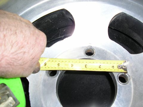 1987 Ford Bronco - A tape measure is used to check the bolt pattern on a vehicle's wheel rim.