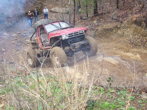 1978 Ford Bronco - This heavily modified truck is navigating a challenging off-road trail.