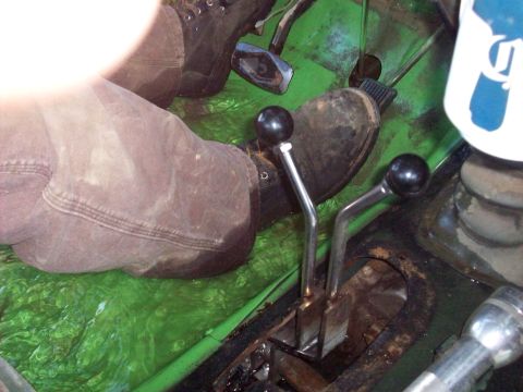1978 Ford Bronco - Close-up view of the driver's side interior, showing feet on pedals and gear shifters.