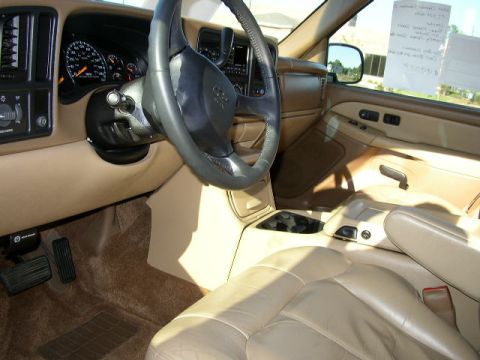 1995 Ford Bronco - The interior of a tan SUV is shown, leather seats, a steering wheel, and dashboard instrumentation.