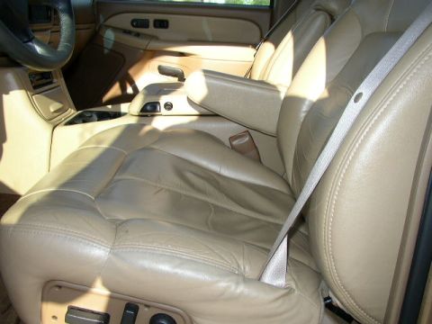 1995 Ford Bronco - Interior view of a vehicle's tan leather seats and center console, with a watermark at the bottom.