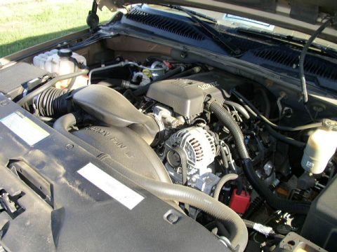 1995 Ford Bronco - The engine bay of a vehicle is shown with the hood open, revealing the VORTEC engine components.