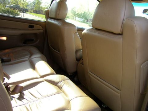 1995 Ford Bronco - The interior of a 2000 Chevrolet Suburban shows tan leather seats and door panels.