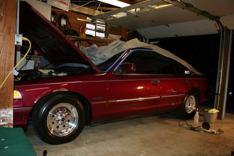 1992 Ford Crown Victoria - A red 1992 Ford Crown Victoria is parked in a garage with its hood open.