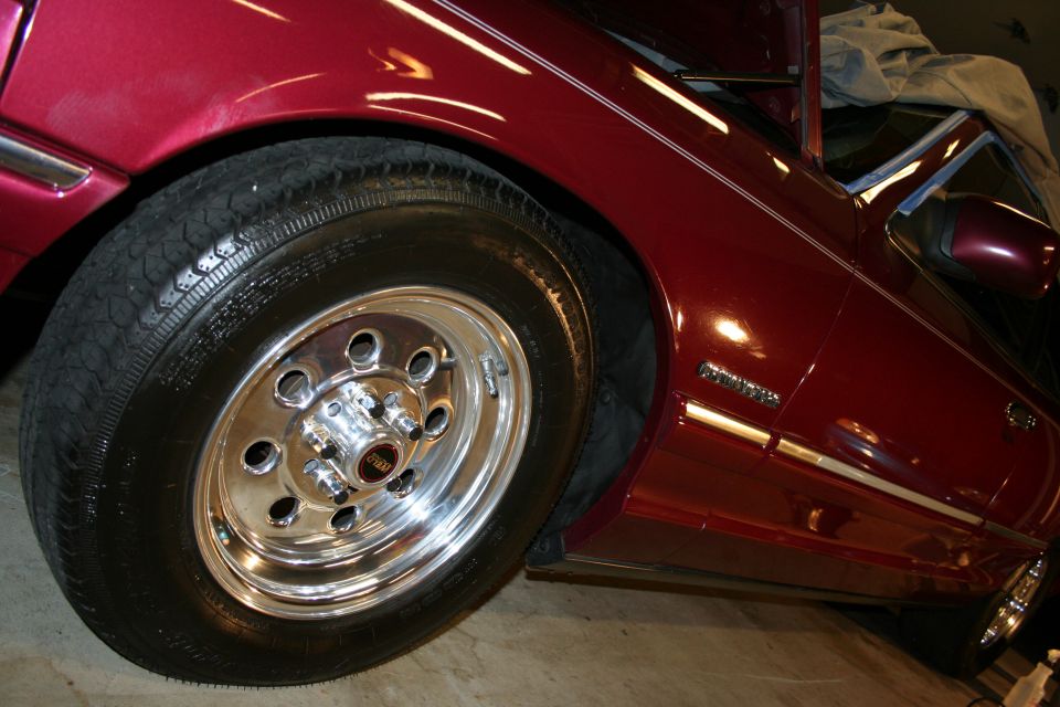 Red 1992 Ford Crown Victoria side view with chrome wheels
