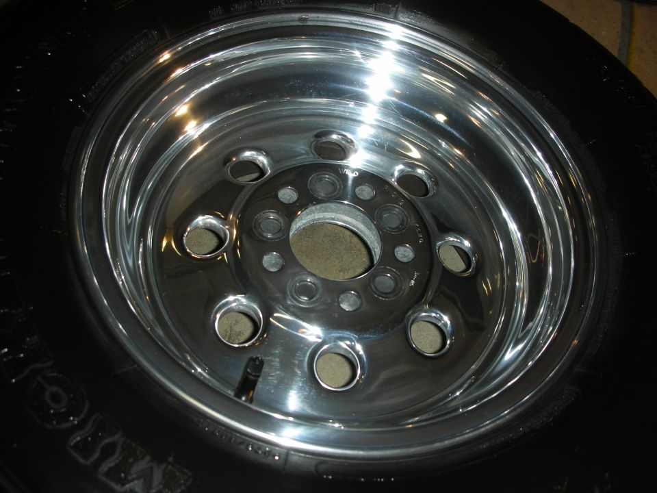 Close-up of a shiny chrome wheel with a black tire