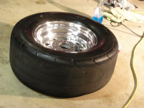 1992 Ford Crown Victoria - A close-up view of a tire and wheel assembly, likely for a performance vehicle, resting on a concrete surface.