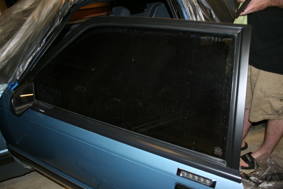 Blue 1990 Ford Mustang door with window being tinted
