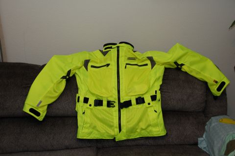 1998 BMW R1100GS ABS - Motorcycle jacket with reflective strips and multiple pockets is displayed on a couch.