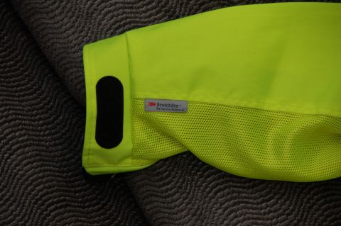 1998 BMW R1100GS ABS - Close-up of a neon yellow jacket sleeve showing a 3M Scotchlite reflective material tag and a black velcro patch.