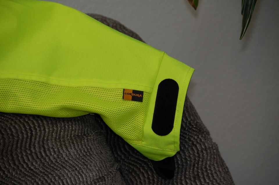 Neon yellow motorcycle jacket sleeve with Cordura label and velcro closure