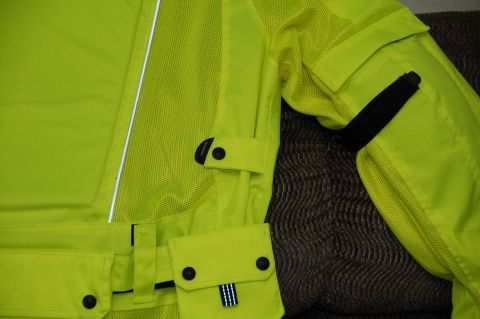 1998 BMW R1100GS ABS - Close-up of a neon yellow motorcycle jacket, showing its construction details and reflective elements.