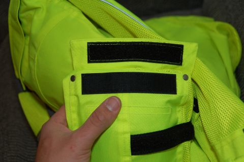 1998 BMW R1100GS ABS - Close-up of a neon yellow motorcycle jacket, showing velcro fasteners and pocket details.