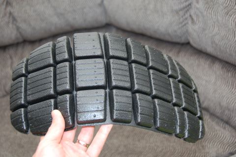1998 BMW R1100GS ABS - A close-up view of a black motorcycle tire tread, with a hand holding the part. The Supermotors.net logo is in the lower right corner.