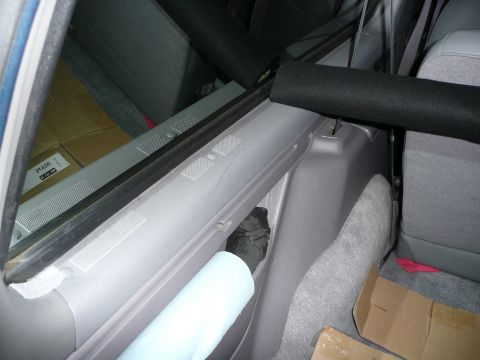 1991 Ford Bronco - Interior view of a vehicle's rear passenger side, showing a window frame and cargo area.