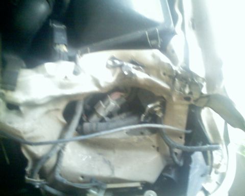 1991 Ford Taurus - Close-up view of a damaged engine bay, showing bent metal and exposed wiring.