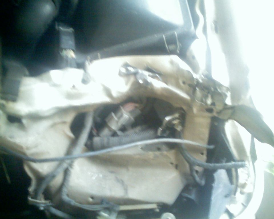 Engine bay with damaged metal and wiring