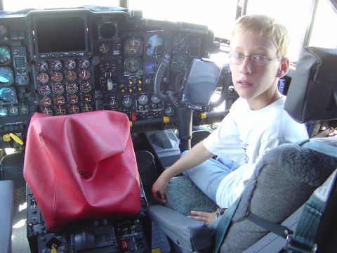 1996 Ford F-250 - A young person sits in the cockpit of what appears to be an aircraft, surrounded by numerous instruments and controls.