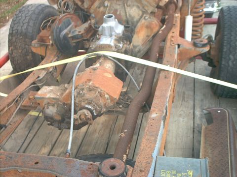 1994 Ford Bronco - Close-up view of heavily rusted chassis and drivetrain components, likely a project vehicle in disrepair.