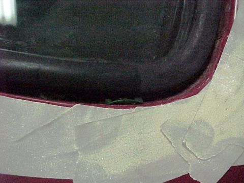 1967 Mercury Cougar - Close-up of a car's door frame and window seal, with white tape applied to the lower section.