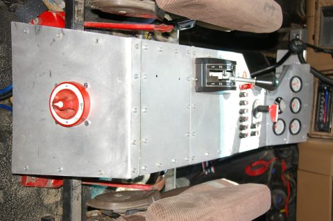 1986 Ford Bronco - Interior view of a custom dashboard a prominent battery cutoff switch and various toggle switches and gauges.