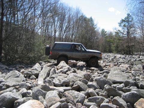 1991 Ford Bronco - Ford Bronco tackles a challenging rocky path during an off-road excursion.