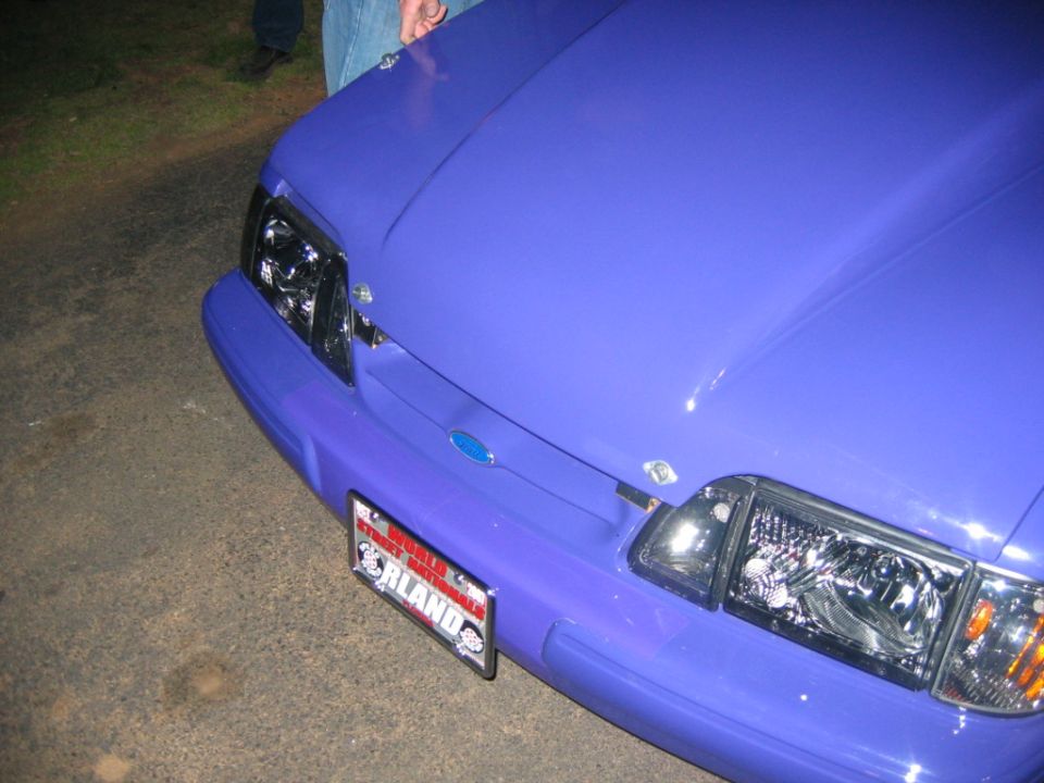 Purple 1992 Ford Mustang front end with aftermarket hood pins and a license plate from Orlando