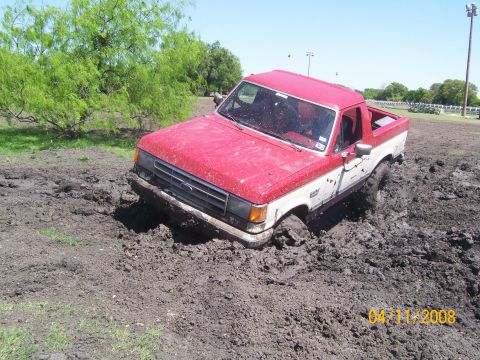 1988 Ford Bronco - This 1988 Ford Bronco is deeply stuck in mud, with only its front end visible above the mire.
