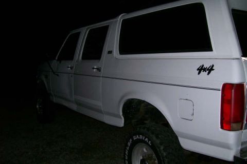 1992 Ford C-350 (Centurion Conversions) - Side view of a 1992 Ford C-350 Centurion Conversions pickup truck, showing the 4x4 decal.