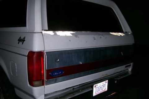 1992 Ford C-350 (Centurion Conversions) - Rear view of a white Ford Bronco with "4x4" badging and a "DOBHOPE" license plate.