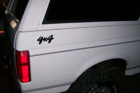 1992 Ford C-350 (Centurion Conversions) - White 1992 Ford C-350 (Centurion Conversions) pickup truck, side view, showing the 4x4 decal.