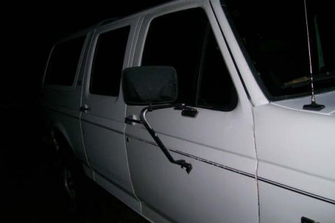 1992 Ford C-350 (Centurion Conversions) - A white van is seen from the side, tinted windows and a prominent side mirror.
