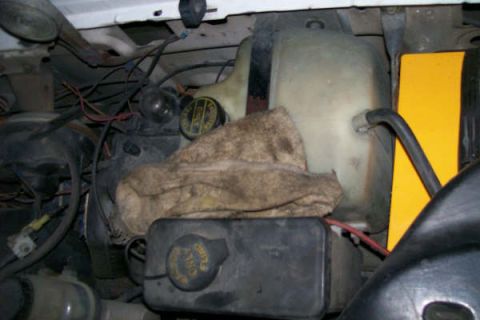 1992 Ford C-350 (Centurion Conversions) - Close-up view of various engine components, including fluid reservoirs and wiring.