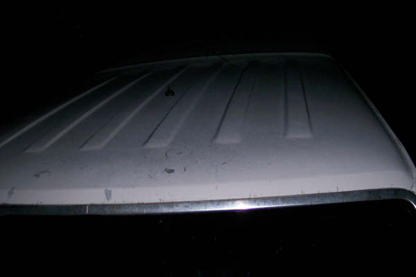 White vehicle roof with raised ribs, chrome trim along the edge
