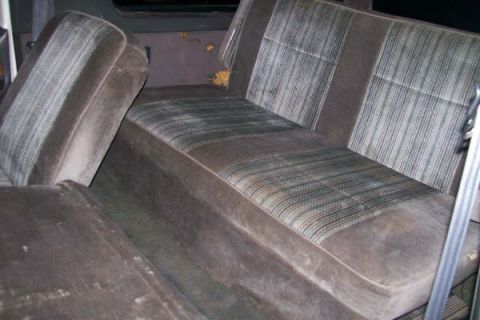 1992 Ford C-350 (Centurion Conversions) - Interior view of worn velour seats, showing the pattern and texture of the upholstery.