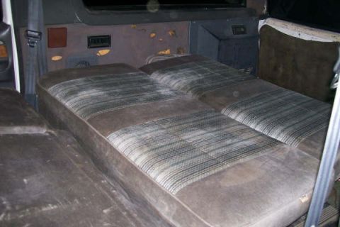 1992 Ford C-350 (Centurion Conversions) - Interior of a van with bench seats, possibly a conversion van.