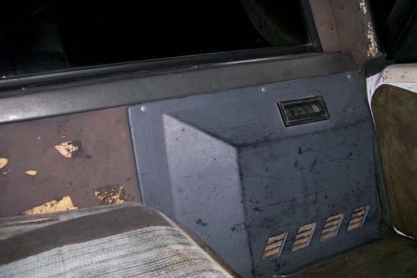 Interior panel with vents and a rectangular vent above. Seat fabric visible
