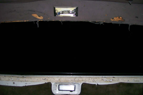 Truck cab windshield opening with glass removed, old sealant and rust on the pinch weld