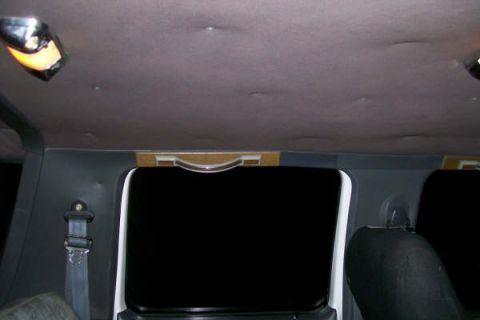 1992 Ford C-350 (Centurion Conversions) - The interior of the van shows the headliner with dome lights and the back of the rear seats.