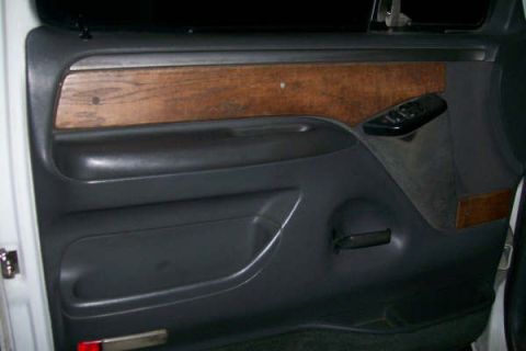 1992 Ford C-350 (Centurion Conversions) - The interior door panel features faux wood trim and dark gray plastic components.