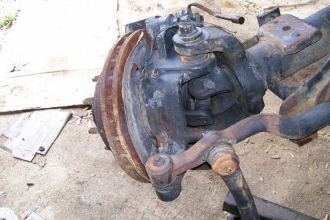 1988 Ford Bronco - Close-up of a Dana 60 front axle assembly, showing brake components and steering linkage.