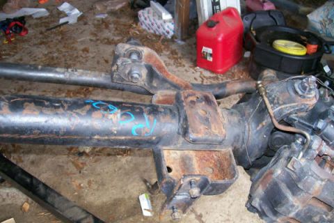 1988 Ford Bronco - A front axle assembly, likely from a truck or SUV, is shown in a workshop setting.